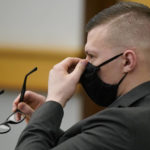 
              Volodymyr Zhukovskyy, of West Springfield, Mass., charged with negligent homicide in the deaths of seven motorcycle club members in a 2019 crash, adjusts his mask at Coos County Superior Court in Lancaster, N.H., Monday, July 25, 2022, before a scheduled visit to the crash scene. Zhukovskyy has pleaded not guilty to multiple counts of negligent homicide, manslaughter, reckless conduct and driving under the influence in the June 21, 2019, crash. (AP Photo/Steven Senne, Pool)
            