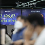 
              Currency traders work near the screens showing the Korea Composite Stock Price Index (KOSPI), left, and the foreign exchange rate between the U.S. dollar and South Korean won at a foreign exchange dealing room in Seoul, South Korea, Thursday, Aug. 18, 2022. Asian stock markets followed Wall Street lower Thursday after the Federal Reserve said U.S. inflation is too high, suggesting support for more aggressive interest rate hikes. (AP Photo/Lee Jin-man)
            