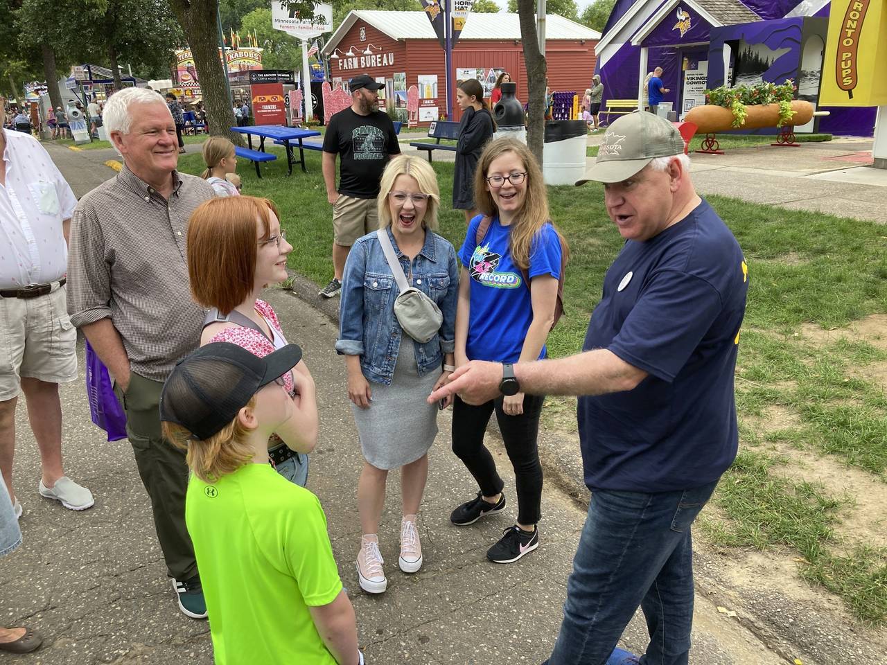 Minnesota Gov. Tim Walz chats with fairgoers on the opening day of the Minnesota State Fair on Thur...