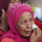 
              Supporters of Malaysia's former Prime Minister Najib Razak cry outside the country's highest court as they wait for a decision on the appeal in Putrajaya, Malaysia Tuesday, Aug. 23, 2022. Malaysia’s top court on Tuesday upheld Najib's graft conviction and 12-year jail sentence linked to the looting of the 1MDB state fund. Najib’s loss in his final appeal means he will have to begin serving his sentence immediately, becoming the first former prime minister to be jailed. (AP Photo/Vincent Thian)
            