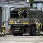 
              FILE - Russian soldiers guard an area as a group of foreign journalists visit in Kherson, Kherson region, south Ukraine, May 20, 2022. The southern city of Kherson was the first to fall to Russia's invasion. But Kherson remains at the heart of the conflict and Ukraine's efforts to save its vital access to the sea. (AP Photo, File)
            