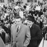 
              FILE - Len Dawson, front, and Fred Arbanas board the plane as a crowd looks on in Kansas City, Dec. 31, 1966, that will take the Kansas City Chiefs AFL Western division champs to Buffalo, N.Y. where they will play the Eastern champs in the New Year's Day title game. Hall of Fame quarterback Len Dawson, who helped the Chiefs to a Super Bowl title, died Wednesday, Aug. 24, 2022. He was 87.(AP Photo/William Straeter, File)
            