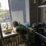 
              Lyubov Mahlii, 76, whistles to two canaries she shares her apartment with in Sloviansk, Donetsk region, eastern Ukraine, Sunday, Aug. 7, 2022. Despite a mandatory evacuation order and the terror that accompanies the shriek of falling rockets, with no money to relocate and nowhere to go, Mahlii plans to stay in Sloviansk, no matter what. "I don't want to leave my apartment because someone else might occupy it," she said. "I don't want to leave, I will die here." (AP Photo/David Goldman)
            