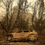 
              A scorched vehicle rests sits next to a driveway as the McKinney Fire burns in Klamath National Forest, Calif., on Sunday, July 31, 2022. (AP Photo/Noah Berger)
            