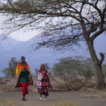 
              Maasai women walk towards the Oltepesi Primary School polling station to vote in Kajiado County, Kenya, Tuesday Aug. 9, 2022. Kenyans are voting to choose between opposition leader Raila Odinga and Deputy President William Ruto to succeed President Uhuru Kenyatta after a decade in power. (AP Photo/Ben Curtis)
            