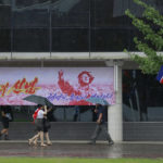 
              Residents walk along Changjon Street past a billboard poster reading "Conviction of sure victory"  commemorating the 77th anniversary of Korea's Liberation in Pyongyang, North Korea, Monday, Aug. 15, 2022. (AP Photo/Cha Song Ho)
            