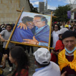 
              Supporters of new President Gustavo Petro display a painting of him with new Vice-President Francia Marquez as they wait for their swearing-in ceremony at the Bolivar square in Bogota, Colombia, Sunday, Aug. 7, 2022. (AP Photo/Ariana Cubillos)
            