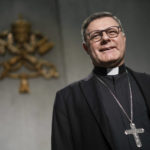 
              Newly named cardinal Paulo Cezar Costa, poses for a photo, during a press conference at the Vatican, Saturday, Aug. 27, 2022. Pope Francis will formally expand the ranks of churchmen now eligible to vote for his successor in case he dies or resigns. Of the 20 churchmen being raised to cardinal’s rank on Saturday in the ceremony known as a consistory in St. Peter’s Basilica, 16 are younger than 80 and thus, according to church law, could participate in a conclave – a ritual-shrouded, locked-door assembly of cardinals who cast paper ballots to elect a new pontiff. (AP Photo/Andrew Medichini)
            