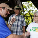 Kentucky Governor Andy Beshear, center, talks with residents that have been displaced by floodwaters at Jenny Wiley State Resort Park Saturday, Aug. 6, 2022, in Prestonsburg, Ky. (AP Photo/Brynn Anderson)