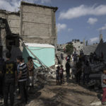
              Palestinians search through the rubble of a building in which Khaled Mansour, a top Islamic Jihad militant was killed following an Israeli airstrike in Rafah, southern Gaza strip, Sunday, Aug. 7, 2022. An Israeli airstrike killed a senior commander in the Palestinian militant group Islamic Jihad, authorities said Sunday, its second leader to be slain amid an escalating cross-border conflict. (AP Photo/Fatima Shbair)
            