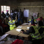 
              An election official holds up ballots for other officials and party agents to see, as they start to count votes at a polling station in Olepolos Primary School, in Kajiado County, Kenya Tuesday, Aug. 9, 2022. Polls opened Tuesday in Kenya's unusual presidential election, where a longtime opposition leader who is backed by the outgoing president faces the deputy president who styles himself as the outsider. (AP Photo/Ben Curtis)
            