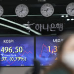 
              A currency trader watches monitors near screens showing the Korea Composite Stock Price Index (KOSPI), left, and the foreign exchange rate between the U.S. dollar and South Korean won at a foreign exchange dealing room in Seoul, South Korea, Thursday, Aug. 18, 2022. Asian stock markets followed Wall Street lower Thursday after the Federal Reserve said U.S. inflation is too high, suggesting support for more aggressive interest rate hikes. (AP Photo/Lee Jin-man)
            
