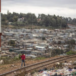 
              A boy walks along a train track and piled trash in Kibera neighborhood, a stronghold of presidential candidate Raila Odinga, in Nairobi, Kenya, Thursday, Aug. 11, 2022. Kenyans are waiting for the results of a close presidential election in which the turnout was lower than usual. (AP Photo/Mosa'ab Elshamy)
            