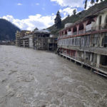 
              Damaged hotels are surrounded by floodwaters in Kalam, Pakistan, Monday, Aug. 29, 2022. Disaster officials say nearly a half million people in Pakistan are crowded into camps after losing their homes in widespread flooding caused by unprecedented monsoon rains in recent weeks. (AP Photo/Sherin Zada)
            