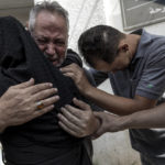 
              Relatives of Muhammad Hassouna, who was killed in an Israeli airstrike mourn before his funeral outside a hospital in Rafah, in the southern Gaza Strip, Sunday, Aug. 7, 2022. An Israeli airstrike in Rafah killed a senior commander in the Palestinian militant group Islamic Jihad, authorities said Sunday, its second leader to be slain amid an escalating cross-border conflict. (AP Photo/Fatima Shbair)
            