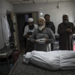 
              The body of Palestinian Muhammad Hassouna, who was killed in an Israeli airstrike is prepared for his funeral at a hospital in Rafah, in the southern Gaza Strip, Sunday, Aug. 7, 2022. An Israeli airstrike in Rafah killed a senior commander in the Palestinian militant group Islamic Jihad, authorities said Sunday, its second leader to be slain amid an escalating cross-border conflict. (AP Photo/Fatima Shbair)
            