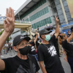 
              Anti-government protesters display the three-finger symbol of resistance during a protest in Bangkok, Thailand, Wednesday, Aug. 24, 2022. Thailand's Constitutional Court ruled Wednesday that Prime Minister Prayuth Chan-ocha must suspend his active duties while the court decides whether he has overstayed his legal term in office. (AP Photo/Sakchai Lalit)
            