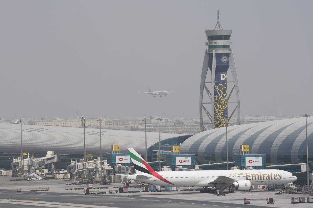 FILE- An Emirates Boeing 777 stands at the gate at Dubai International Airport as another prepares ...