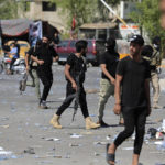 
              Fighters from the Saraya Salam (Peace Brigades) loyal to influential Shiite Iraqi cleric Muqtada al-Sadr deploy in Baghdad, Iraq, Tuesday, Aug. 30, 2022. Al-Sadr has called on his supporters to withdraw from the capital's government quarter. His supporters have traded heavy fire with security forces there in a serious escalation of a months-long political crisis gripping the nation. (AP Photo/Murtadha Ridha)
            