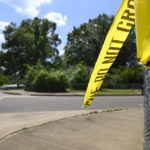 
              FILE - A remnant of crime scene tape hangs on a fence in the neighborhood of Whitehaven in Memphis, Tenn., where Ezekiel Kelly was arrested on Sept. 8, 2022, after he livestreamed himself driving around Memphis shooting at people in seemingly random attacks the night before, Sept. 7, 2022. A court hearing for Kelly, who is charged with murder in connection with the series of shootings in Memphis, was postponed Tuesday, Sept. 27, 2022, when three state witnesses did not show up for the proceedings. (AP Photo/John Amis, File)
            