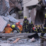 
              In this photo provided by Hualien City Government, firefighters are seen at a collapsed building during a rescue operation following an earthquake in Yuli township, Hualien County, eastern Taiwan, Sunday, Sept. 18, 2022. A strong earthquake shook much of Taiwan on Sunday, toppling at least one building and trapping two people inside and knocking part of a passenger train off its tracks at a station.(Hualien City Government via AP)
            