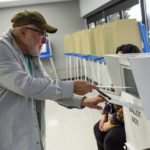 
              A voter turns in his ballot on Friday, Sept. 23, 2022, in Minneapolis. With Election Day still more than six weeks off, the first votes of the midterm election were already being cast Friday in a smattering of states including Minnesota. (AP Photo/Nicole Neri)
            