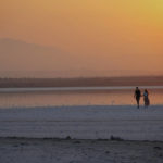 
              FILE - A couple walk at the salt lake during sunset in southeast coastal city of Larnaca in southeast Mediterranean island of Cyprus, on Sept. 5, 2022. The eastern Mediterranean and Middle East are warming almost twice as fast as the global average, with temperatures projected to rise up to 5 degrees Celsius (9 degrees Fahrenheit) by the end of the century if no action is taken to reverse the trend, a new report says. (AP Photo/Petros Karadjias, File)
            