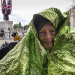 
              Caryll Foster keeps herself warm with foil as she will stay overnight to be in the first row for the Queen's funeral at the mall in front of Buckingham Palace in London, England, Sunday, Sept. 18, 2022. The funeral of Queen Elizabeth II, Britain's longest-reigning monarch, takes place on Monday. (AP Photo/Martin Meissner)
            