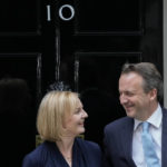 
              New British Prime Minister Liz Truss and her husband Hugh O'Leary pose outside Downing Street in London, Tuesday, Sept. 6, 2022, after returning from Balmoral in Scotland where she was formally appointed by Britain's Queen Elizabeth II. (AP Photo/Frank Augstein)
            