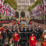 
              The coffin of Queen Elizabeth II is pulled past Buckingham Palace following her funeral service in Westminster Abbey in central London, Monday, Sept. 19, 2022. The Queen, who died aged 96 on Sept. 8, will be buried at Windsor alongside her late husband, Prince Philip, who died last year. (AP Photo/Vadim Ghirda, Pool)
            