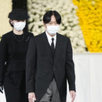 
              Japan's Crown Prince Akishino, right, and Crown Princess Kiko walks on stage after paying their respects during the state funeral of former Japanese Prime Minister Shinzo Abe at the Nippon Budokan, Tuesday, Sept. 27, 2022, in Tokyo. (Franck Robichon/Pool Photo via AP)
            
