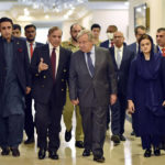 
              In this handout photo released by Pakistan Prime Minister Office, U.N. Secretary-General Antonio Guterres, center, walk with Pakistan Prime Minister Shahbaz Sharif as they chat with each others at the Prime Ministry office in Islamabad, Pakistan, Friday, Sept. 9, 2022. Guterres appealed to the world to help Pakistan after arriving in the country Friday to see climate-induced devastation from months of deadly record floods that have left half a million people living in tents under the open sky. (Pakistan Prime Minister Office via AP)
            