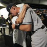 
              New York Yankees' Aaron Judge hugs his mother, Patty Judge, after the team's baseball game against the Toronto Blue Jays on Wednesday, Sept. 28, 2022, in Toronto. Judge hit his 61st home run of the season. (Nathan Denette/The Canadian Press via AP)
            