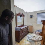 
              Nelson Cirino sees his bedroom after the winds of hurricane Fiona tore the roof off his house in Loiza, Puerto Rico, Sunday, Sept. 18, 2022. (AP Photo/Alejandro Granadillo)
            