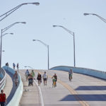 
              Residents and business owners cross the bridge to Fort Myers Beach, Fla., at San Carlos Boulevard and Main Street, on Thursday, Sept. 29, 2022. The island is not yet open to the general public. (Amy Beth Bennett/South Florida Sun-Sentinel via AP)
            
