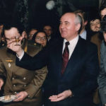 
              Soviet Union President Mikhail Gorbachev toasts with a small glass of lemon-flavored vodka at a going-away party for his staff on Dec. 26, 1991, the day after his nationally televised address in which he announced his resignation as president, in Moscow. Associated Press correspondent Brian Friedman is back right of Gorbachev. (AP Photo/Alexander Zemlianichenko)
            