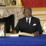 
              Former Mozambique President Joaquim Chissano signs a book of condolences at Lancaster House following the death of Queen Elizabeth II, in London, Sunday, Sept. 18, 2022. ( Jonathan Hordle/Pool Photo via AP)
            