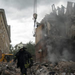 
              Firefighters work to extinguish a fire, looking for potential victims after a Russian attack that heavily damaged a residential building in Sloviansk, Ukraine, Wednesday, Sept. 7, 2022. (AP Photo/Leo Correa)
            