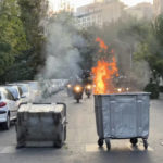 
              In this Tuesday, Sept. 20, 2022, photo taken by an individual not employed by the Associated Press and obtained by the AP outside Iran, a trash bin is burning as anti-riot police arrive during a protest over the death of a young woman who had been detained for violating the country's conservative dress code, in downtown Tehran, Iran. Iran faced international criticism on Tuesday over the death of a woman held by its morality police, which ignited three days of protests, including clashes with security forces in the capital and other unrest that claimed at least three lives. (AP Photo)
            