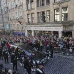 
              The procession with the coffin of Queen Elizabeth II, followed by King Charles III, Princess Anne, Prince Edward and Prince Andrew, heads up the Royal Mile to St Giles' Cathedral in Edinburgh, Monday, Sept. 12, 2022. Britain's longest-reigning monarch who was a rock of stability across much of a turbulent century, died Thursday Sept. 8, 2022, after 70 years on the throne. She was 96. (AP Photo/Scott Heppell)
            
