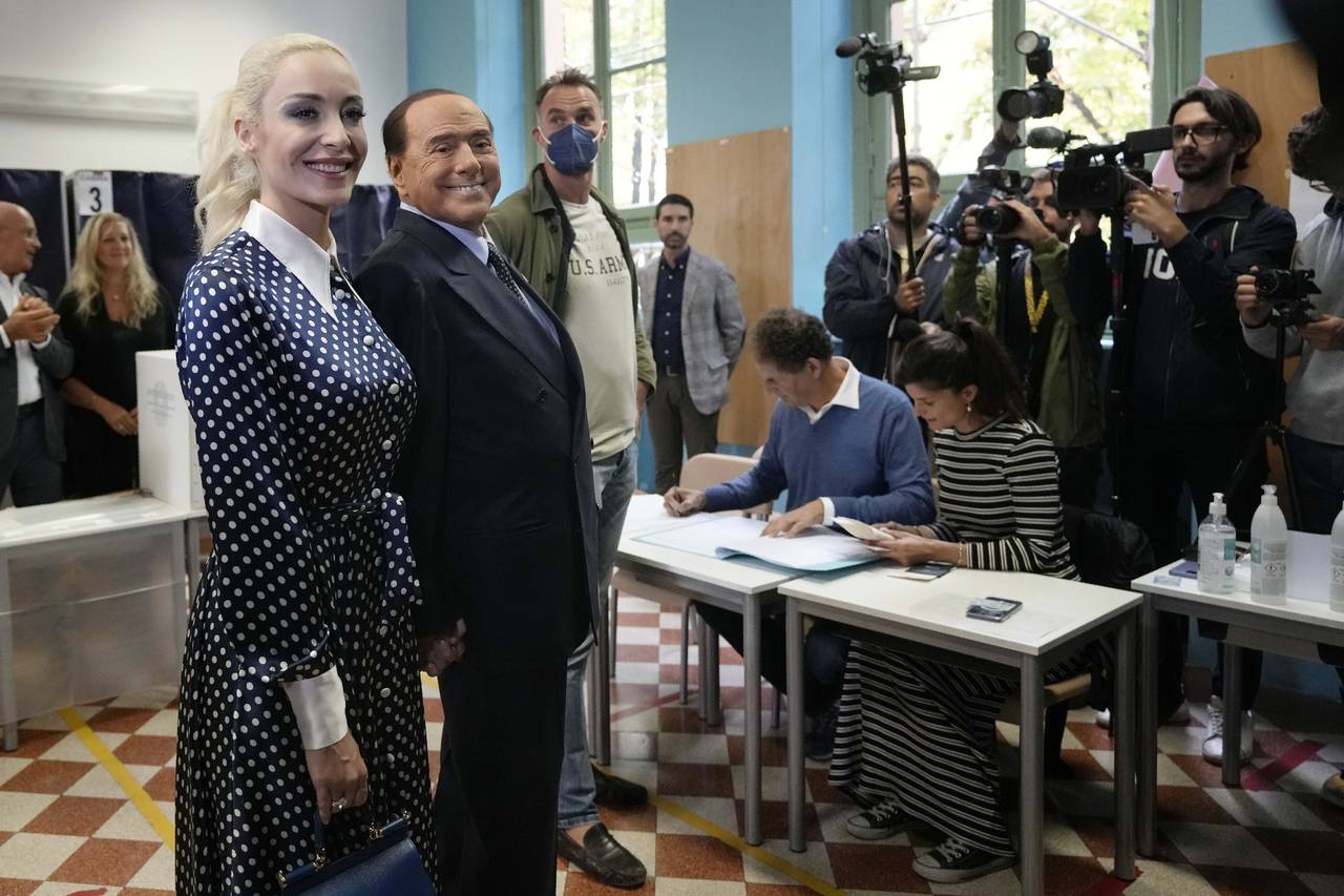 FILE -  Silvio Berlusconi, leader of center-right, populist Forza Italia is flanked by his partner ...