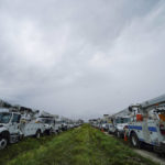 
              Utility trucks are staged ahead of Hurricane Ian, near the Florida Turnpike, Wednesday, Sept. 28, 2022, in Wildwood, Fla. (AP Photo/Gerald Herbert)
            