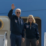 
              President Joe Biden waves as first lady Jill Biden watches standing at the top of the steps of Air Force One before boarding at Andrews Air Force Base, Md., Saturday, Sept. 17, 2022. To commemorate the U.S. Air Force's 75th Anniversary, the Bidens are wearing Air Force One jackets. (AP Photo/Gemunu Amarasinghe)
            