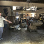 
              Brandon Gallegos, left, whose family owns the Oak Glen Steakhouse and Saloon, shows the level of the mudslide damage inside the Oak Glen Steakhouse and Saloon in Oak Glen, Calif., on Wednesday, Sept. 14, 2022. (AP Photo/Amy Taxin)
            