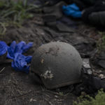 
              A damaged helmet is seen on the ground of a site where four bodies of Ukrainian soldiers where found in an area near the border with Russia, in Kharkiv region, Ukraine, Monday, Sept. 19, 2022. In this operation seven bodies of Ukrainian soldiers were recovered from what was the battlefield in recent months. (AP Photo/Leo Correa)
            
