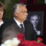 
              Hungary's Prime Minister Viktor Orban walks to the coffin of former Soviet President Mikhail Gorbachev inside the Pillar Hall of the House of the Unions during a farewell ceremony in Moscow, Russia, Saturday, Sept. 3, 2022. Gorbachev, who died Tuesday at the age of 91, will be buried at Moscow's Novodevichy cemetery next to his wife, Raisa, following a farewell ceremony at the Pillar Hall of the House of the Unions, an iconic mansion near the Kremlin that has served as the venue for state funerals since Soviet times. (AP Photo/Alexander Zemlianichenko)
            