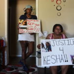 
              Audrey Tate, left, and Beverly Wray, right, hold signs for their late niece on Thursday, Sept. 1, 2022 in Gaffney, S.C. The South Carolina family is seeking justice for Kesha Tate killed by her neighbor who was intoxicated and making target practice in his backyard. Nicholas Skylar Lucas is accused of murder in the shooting death of  Tate after crime scene technicians debunked his claim that the shots ricocheted off his target.(AP Photo/James Pollard)
            