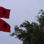 
              Hurricane warning flags fly in front of the fire station and town hall as the effects from Hurricane Ian are felt, Thursday, Sept. 29, 2022, in Sullivan's Island, S.C. (AP Photo/Alex Brandon)
            