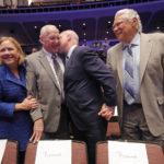 
              FILE - Outgoing New Orleans Mayor Mitch Landrieu kisses his father, former New Orleans Mayor Moon Landrieu, before they pose for a photo with his sister, former Sen. Mary Landrieu, D-La., and former New Orleans Mayor Sidney Barthelemy, right, before the inauguration of newly elected New Orleans Mayor Latoya Cantrell in New Orleans, Monday, May 7, 2018. Moon Landrieu, the patriarch of a Louisiana political family who was a lonely voice for civil rights until the tide turned in the 1960s, has died at age 92. A family friend said Landrieu died Monday, Sept. 5, 2022. (AP Photo/Gerald Herbert, File)
            