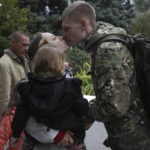 
              A Russian recruit and his wife kiss outside a military recruitment center in Volzhskiy, Volgograd region, Russia, Wednesday, Sept. 28, 2022. Russian President Vladimir Putin has ordered a partial mobilization of reservists to beef up his forces in Ukraine. (AP Photo)
            
